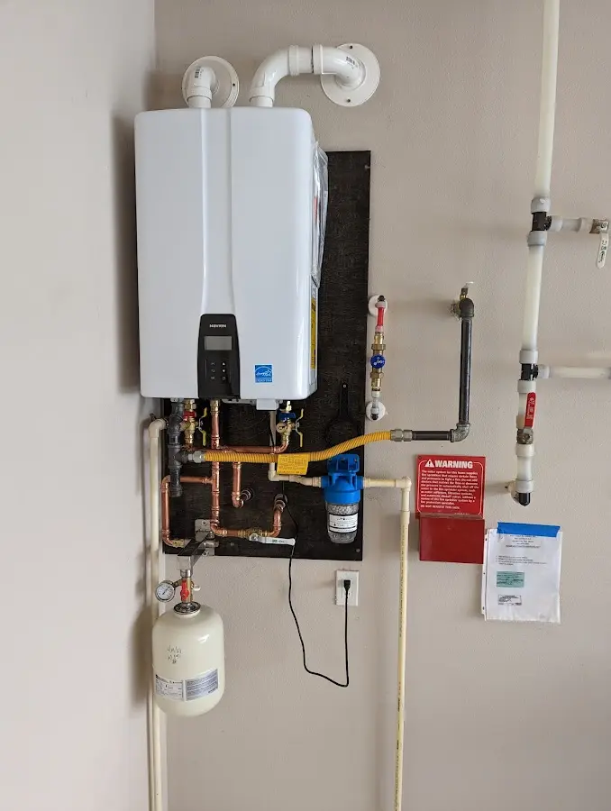 Professional plumber installing copper piping in a Scott City home